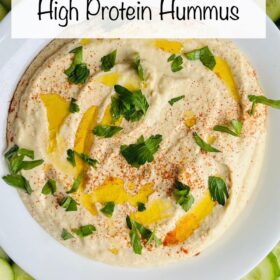 Hummus sprinkled with chopped parsley and drizzled with olive oil.
