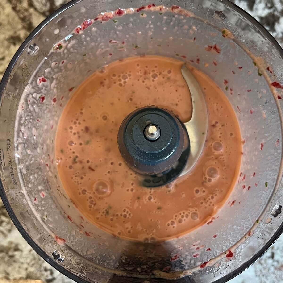 Blended cherry dressing in a food processor.