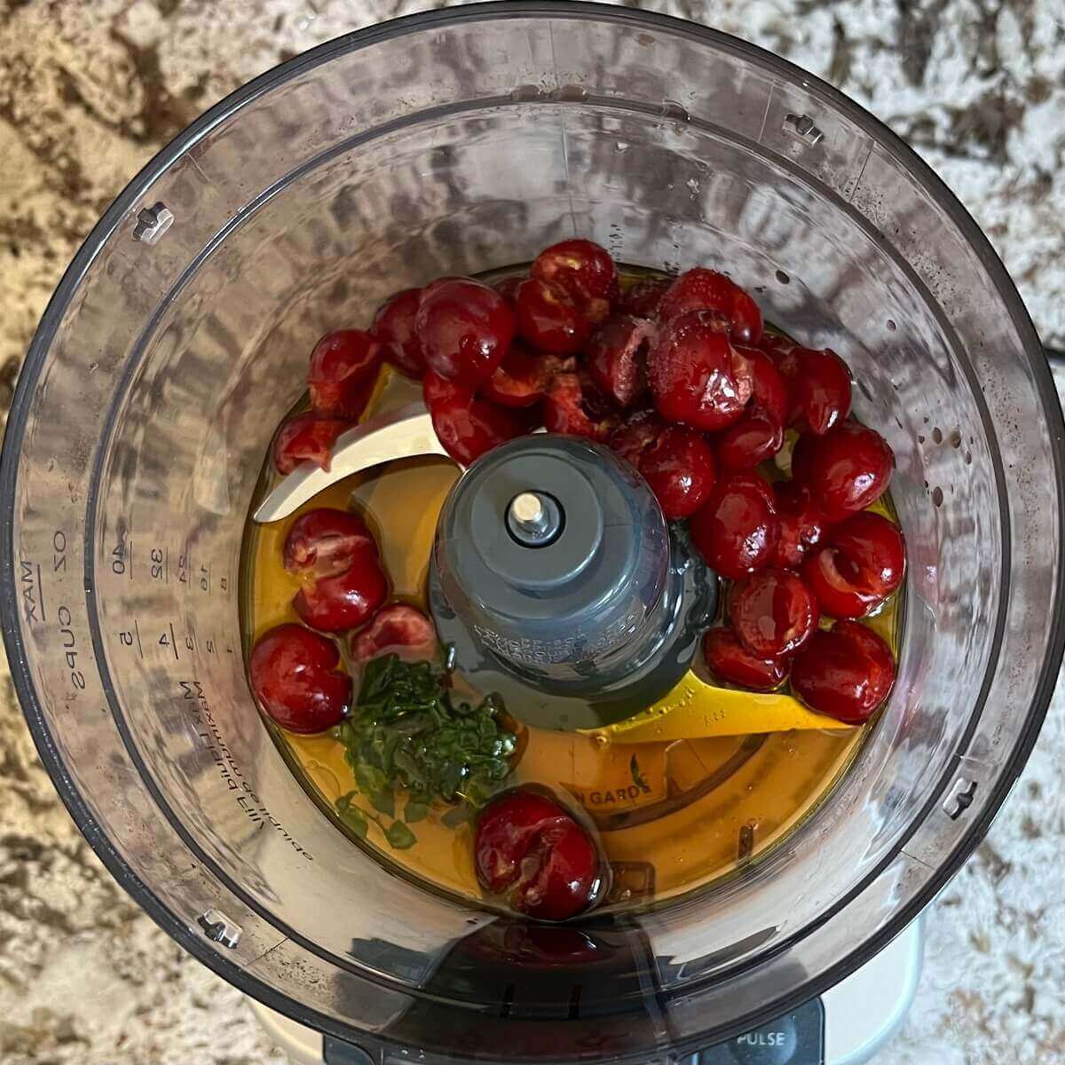 Ingredients for cherry dressing in a food processor.