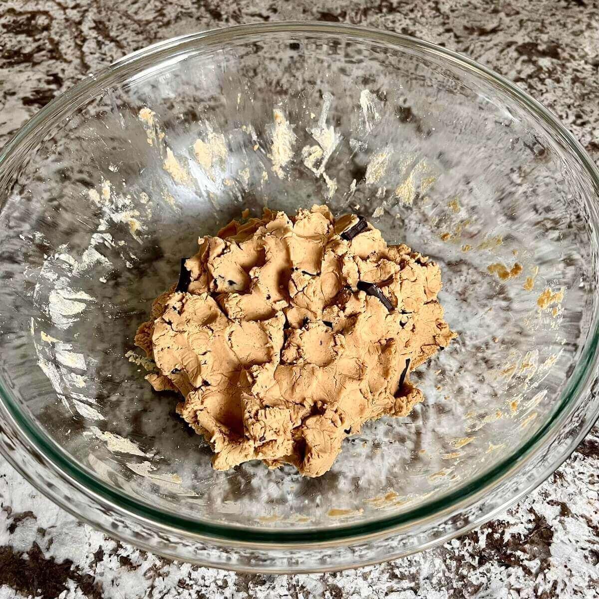 Pea protein cookie dough in a glass bowl.