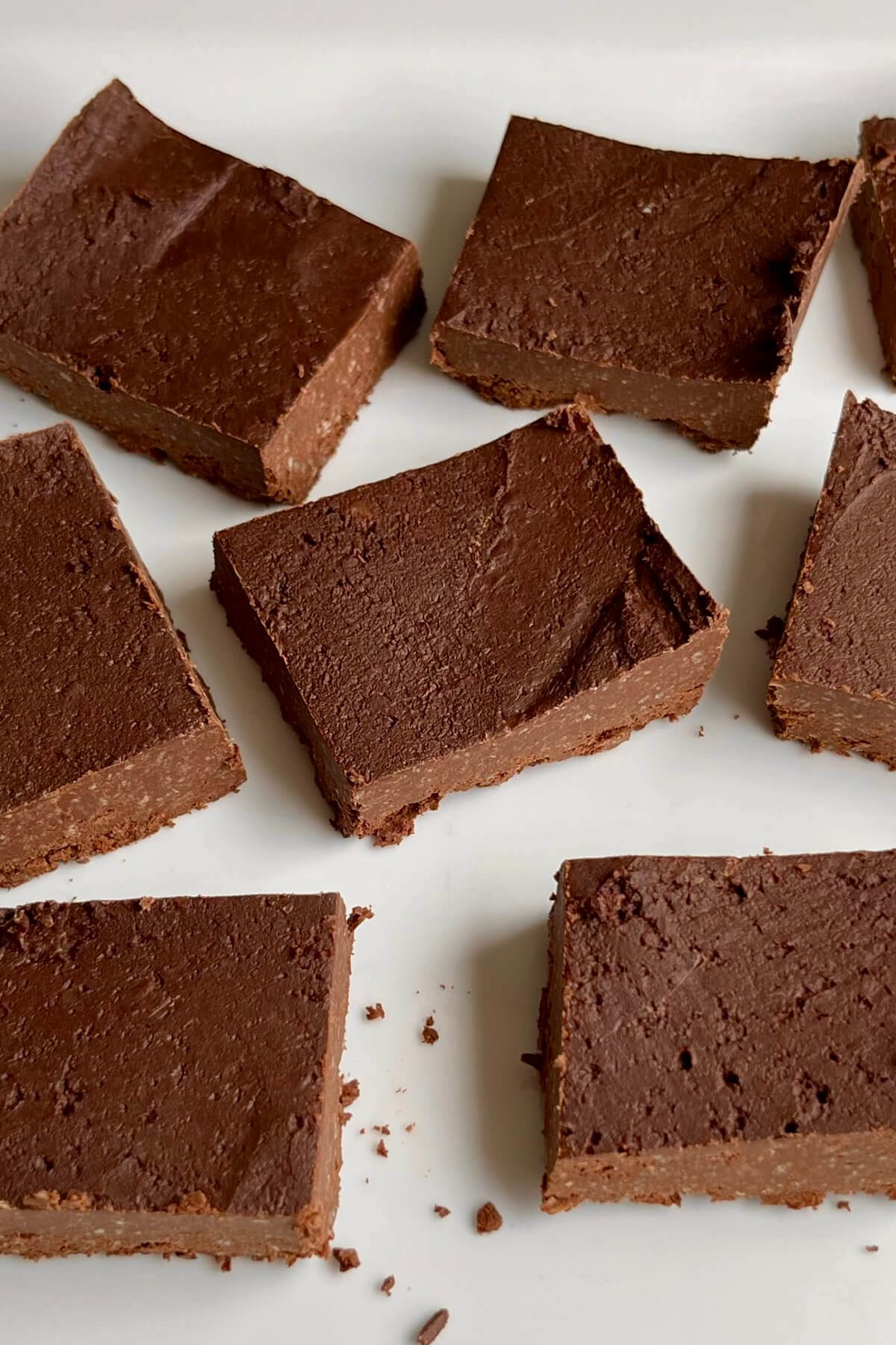 Fudge made from chickpeas and dark chocolate on a white plate.