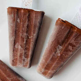 Homemade popsicles on a white plate.