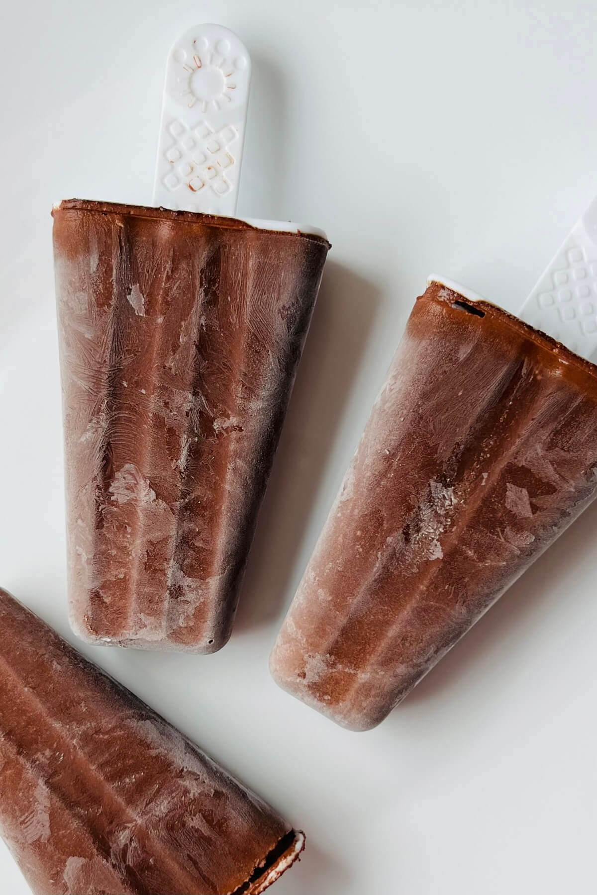 Homemade popsicles on a white plate.