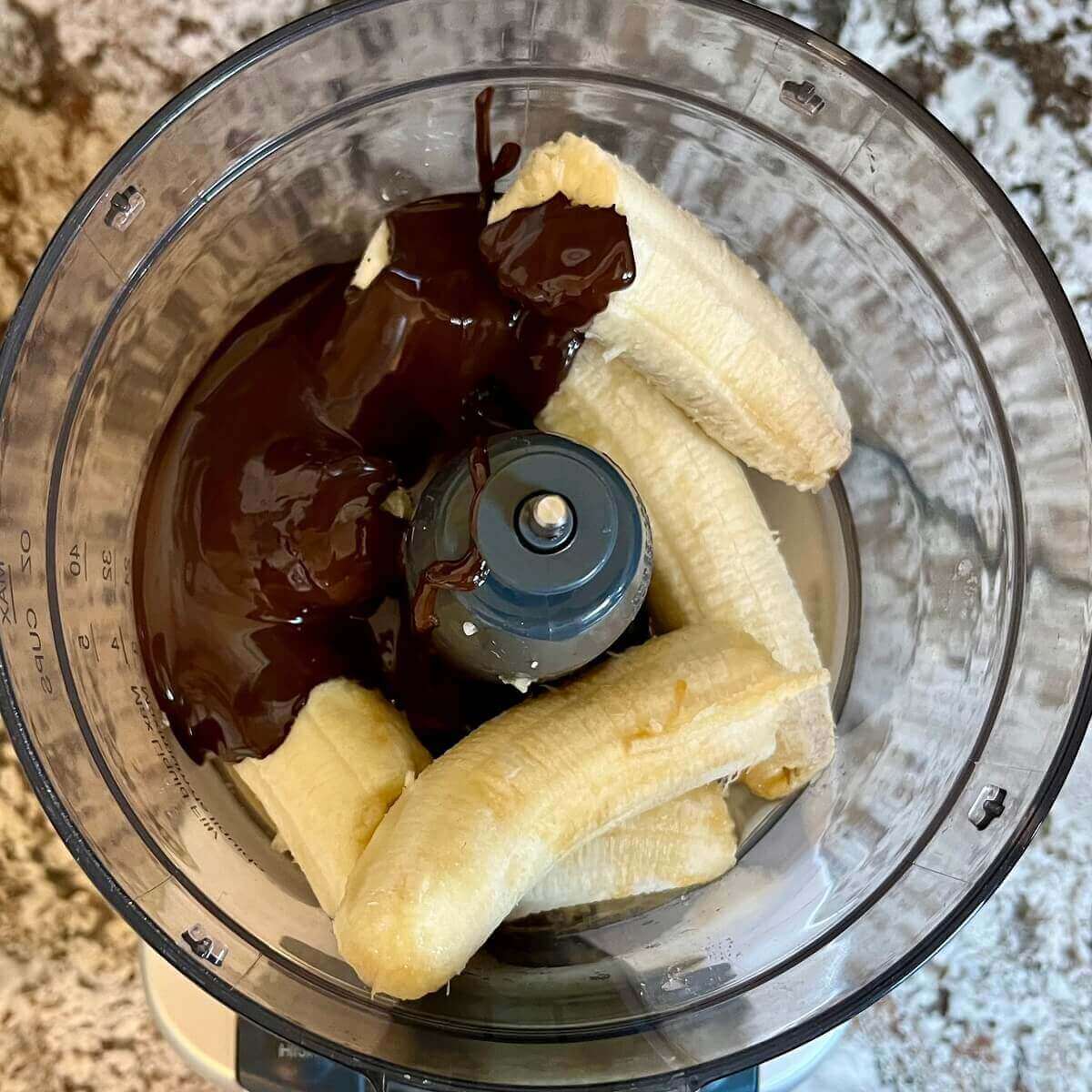 Ingredients for banana mousse in a food processor.