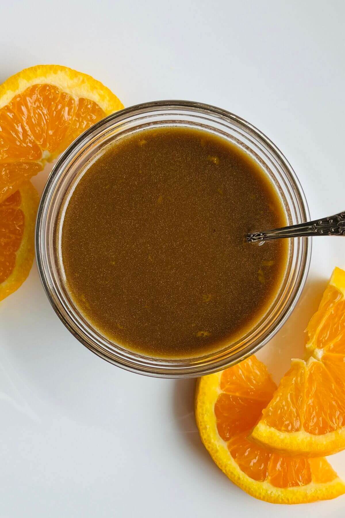 Orange vinaigrette in a glass bowl.