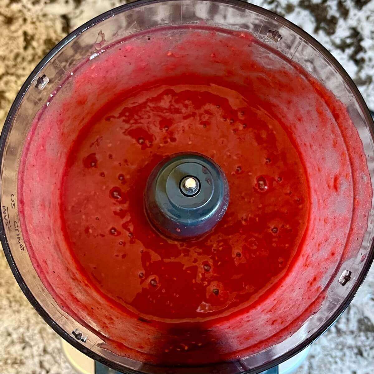 A raspberry mixture blended in a food processor.