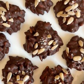 Treats made with chocolate and sunflower seeds on a white plate.