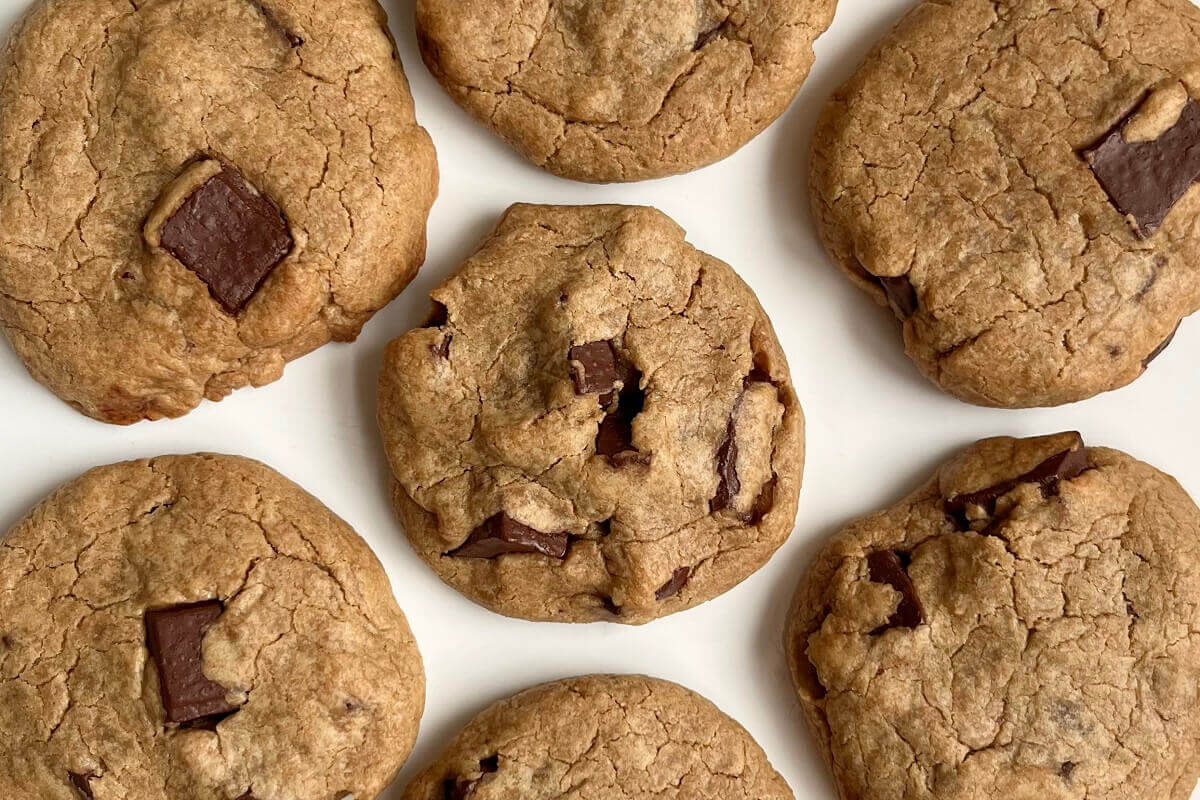 Sunflower seed chocolate chunk cookies on a white plate.