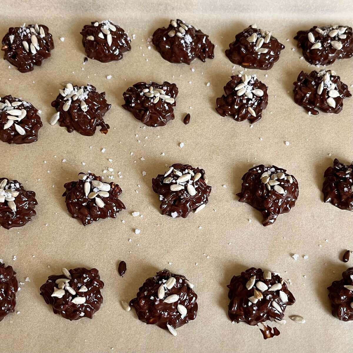 Sunflower seed clusters on a sheet pan lined with parchment paper.